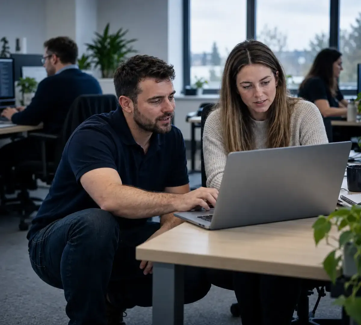 IT support Hampshire engineer helping a member of staff with her laptop in an office